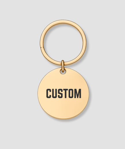 Ronde gouden sleutelhanger met zwarte tekst CUSTOM gravure