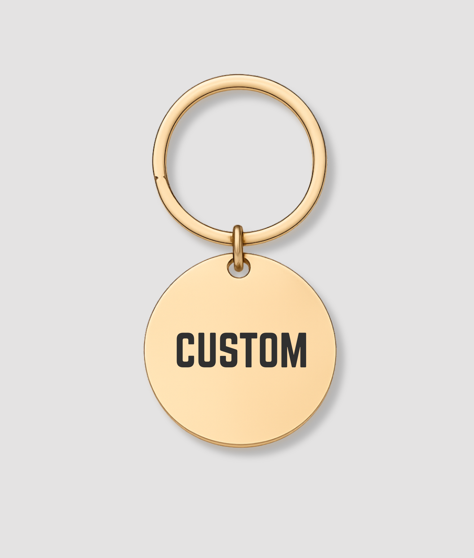 Ronde gouden sleutelhanger met zwarte tekst CUSTOM gravure