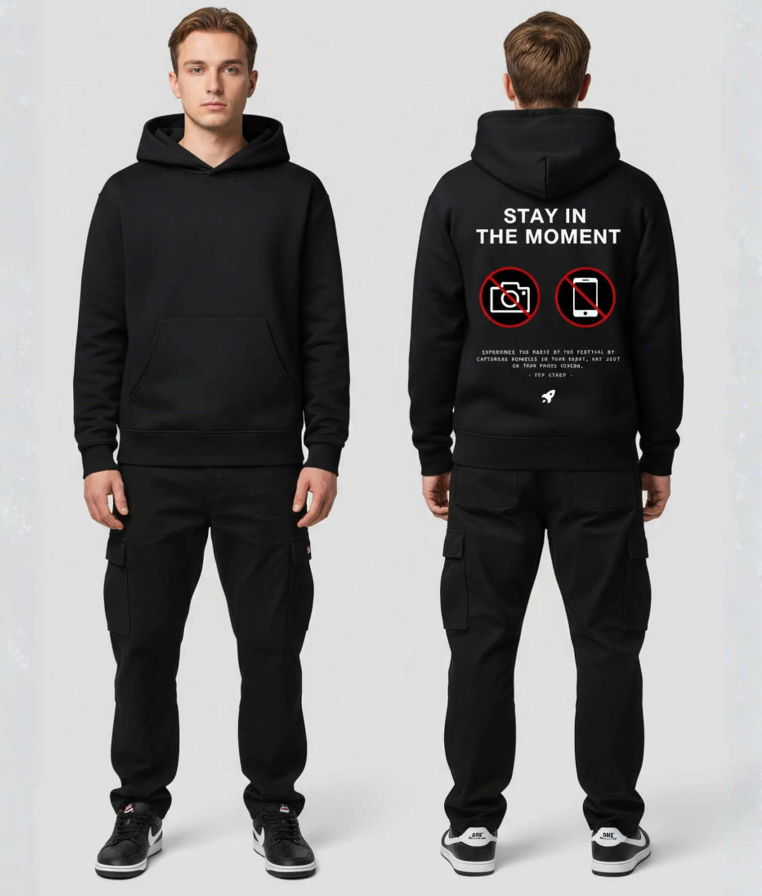 Man in zwarte hoodie met tekst STAY IN THE MOMENT en no-camera iconen op de rug