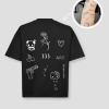 Zwart oversized unisex t-shirt met tattoo-geïnspireerde opdrukken van PEP SCHEP – voorkant print met witte illustraties zoals panda, hart, bloem en typografie