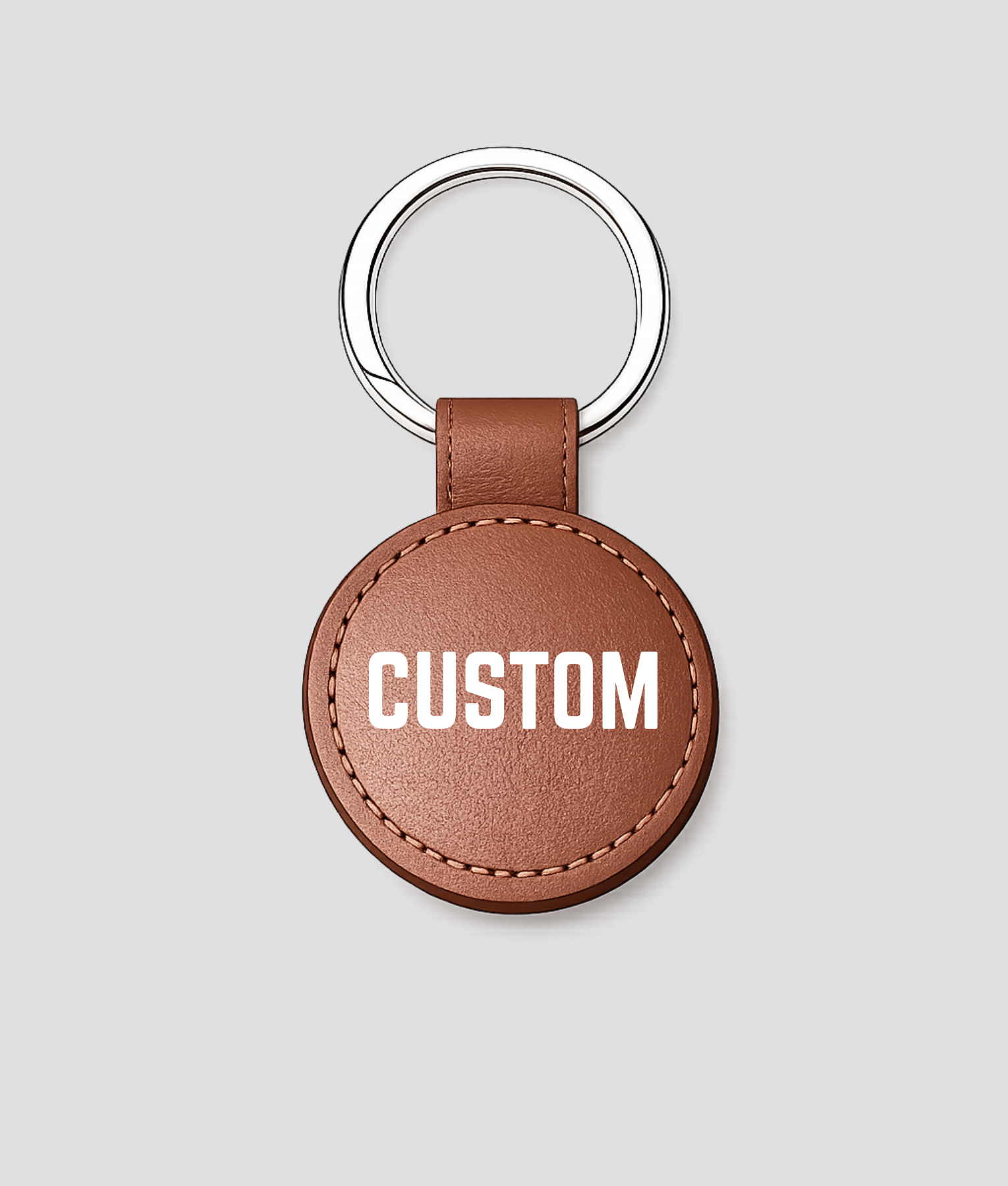 Bruine ronde leren sleutelhanger, voorbeeldtekst 'CUSTOM'