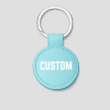 Turquoise ronde leren sleutelhanger met zilveren ring, voorbeeldtekst 'CUSTOM'