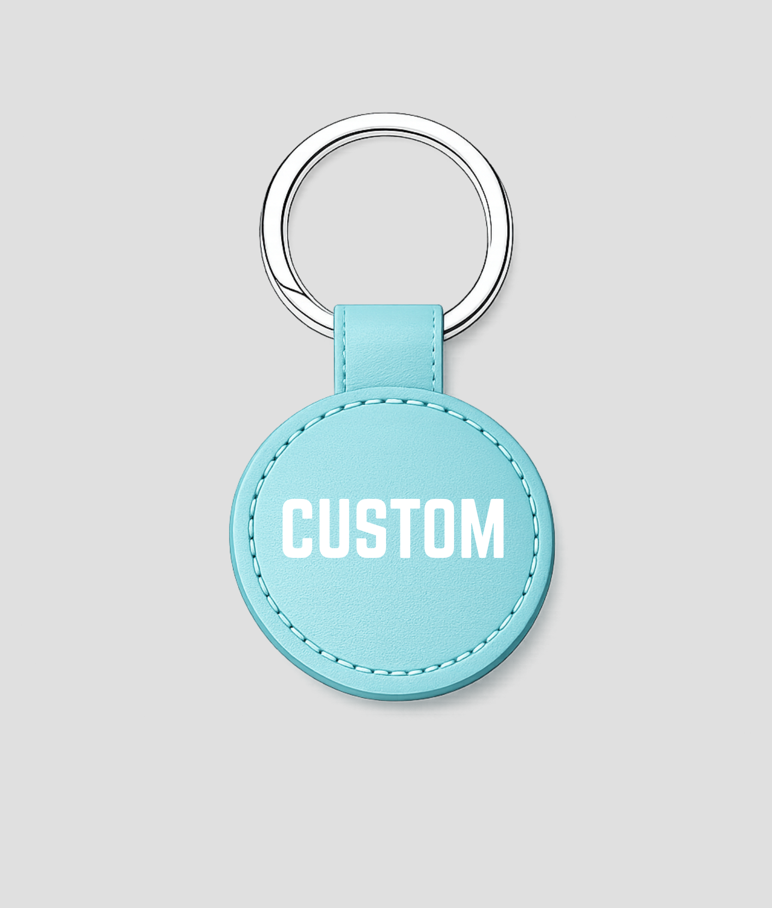 Turquoise ronde leren sleutelhanger met zilveren ring, voorbeeldtekst 'CUSTOM'