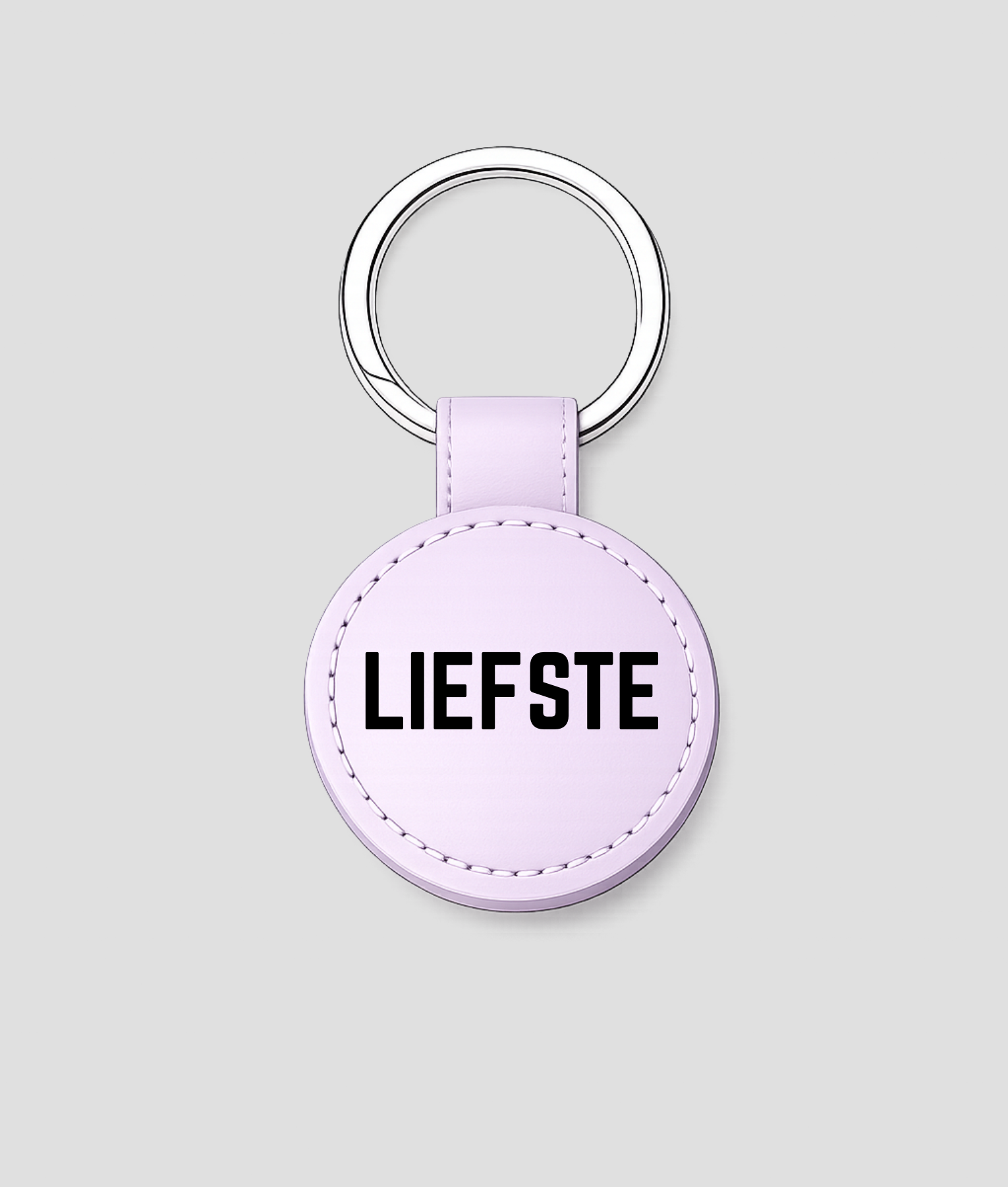 Lila ronde leren sleutelhanger met zilveren ring en tekst 'BESTE JUF'