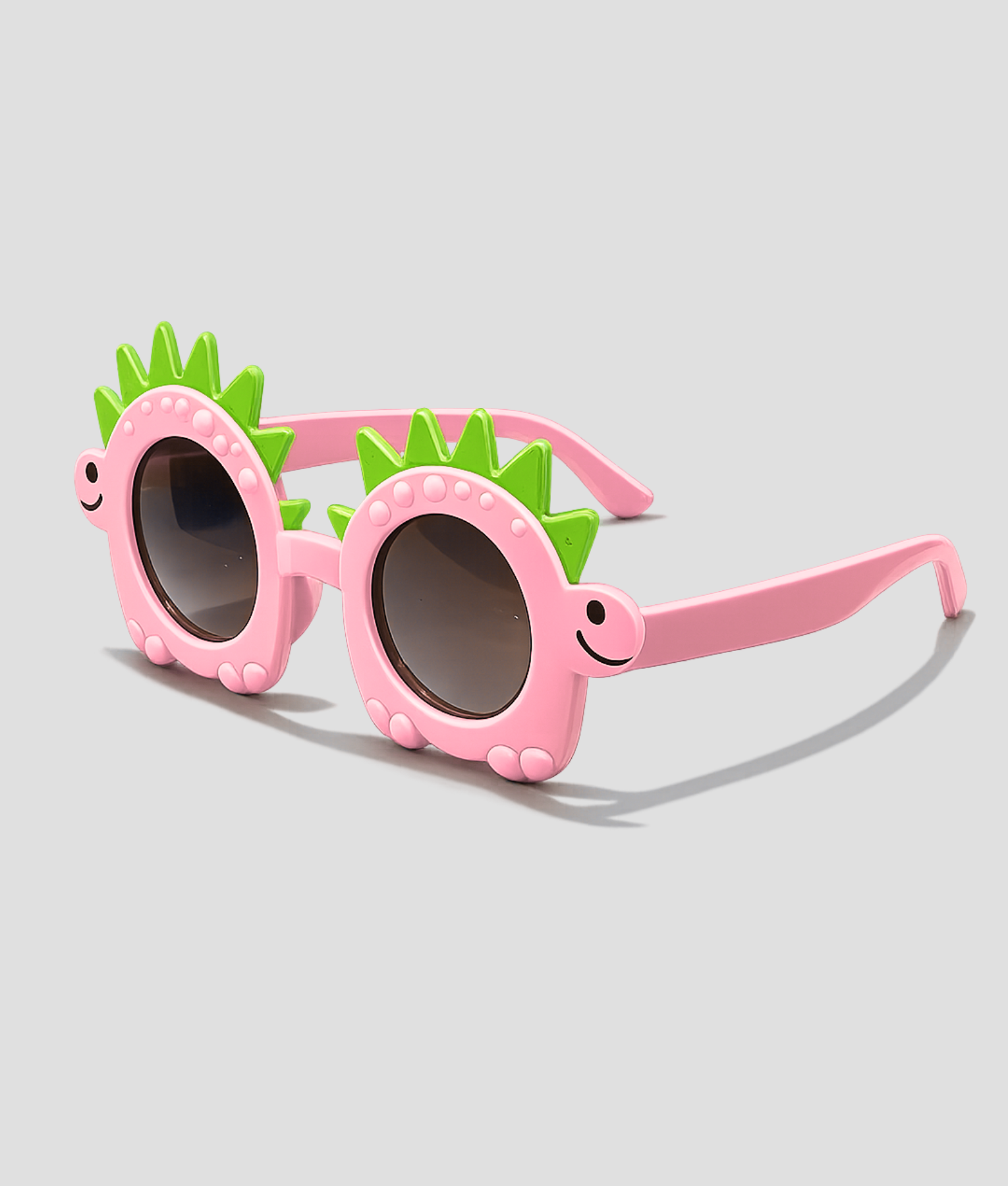 Roze kinderzonnebril in de vorm van een dinosaurus