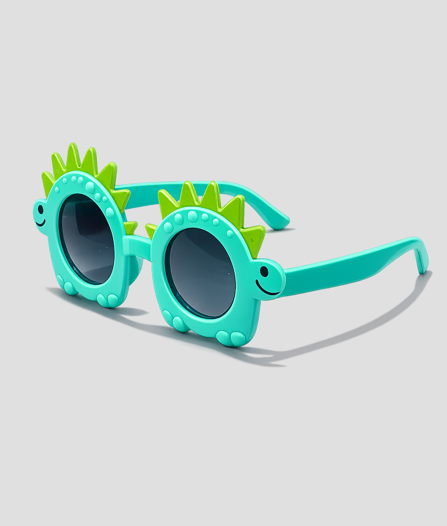 Turquoise kinderzonnebril in de vorm van een dinosaurus